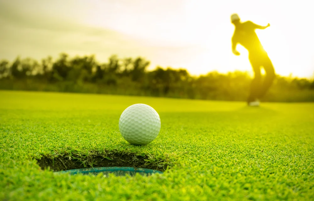 golfer - celebrating after golf injury clinic treatment wimbledon